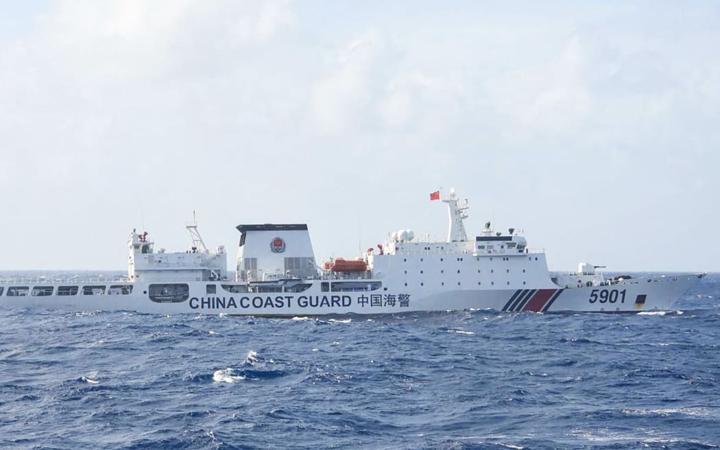 This handout photo taken on January 11, 2025 and released on January 12 by the Philippine Coast Guard (PCG) shows a Chinese Coast Guard ship sailing some 60 nautical miles (111 kilometres, 69 miles) west of the main Philippine island of Luzon while being monitored by Philipine Coast Guard ship BRP Teresa Magbanua (not pictured). The Philippines on January 12 accused China of pushing its patrol ships close to the main Filipino landmass as part of Beijing's alleged illegal grab of most of the South China Sea. (Photo by Handout / Philippine Coast Guard (PCG) / AFP) / RESTRICTED TO EDITORIAL USE - MANDATORY CREDIT "AFP PHOTO / PHILIPPINE COAST GUARD (PCG)" - NO MARKETING NO ADVERTISING CAMPAIGNS - DISTRIBUTED AS A SERVICE TO CLIENTS