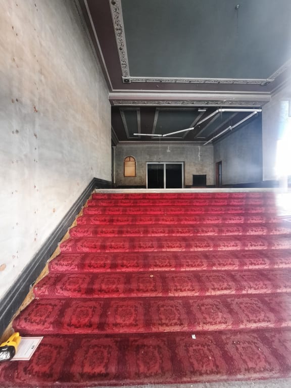 The main foyer can still be seen from the street, but no customers have walked up the stairs in years.