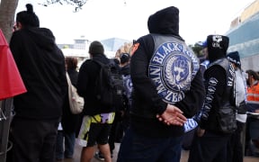 AUCKLAND, NEW ZEALAND - MAY 30: Black Power gang members wearing insignia join a march down Queen St on May 30, 2024 in Auckland, New Zealand. The nationwide day of activation saw Hikoi, or protest marches, take place around the country. Organisers said on Instagram that the action was intended to demonstrate a unified Aotearoa response to the current government's handling of Treaty of Waitangi matters and relationship with New Zealand's Indigenous Maori population. The action co-insided with the presentation of the budget in parliament. (Photo by Fiona Goodall/Getty Images)