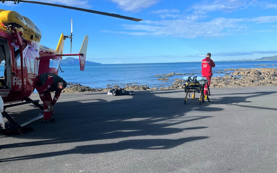 The Westpac Rescue Helicopter on Kāpiti Coast waiting to take the man to hospital.