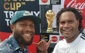 Solomon Islands National Football captain Henry Fa'arodo poses infront of the the FIFA World CUp Trophy with France's Christian Karembeu in Honiara, Solomon Islands. 01 February 2018