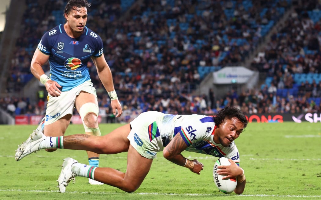 Adam Pompey of the Warriors scores a try against Gold Coast Titans.