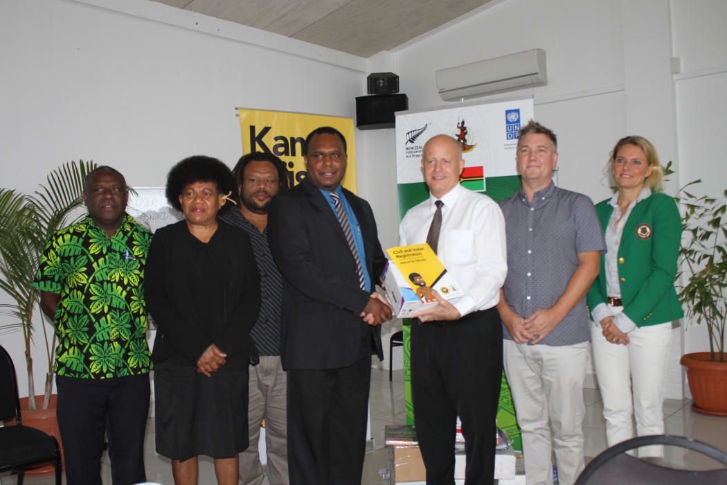 New Zealand High Commissioner to Vanuatu Jonathan Schwass handing over equipment to Cabinet Minister Andrew Napuat