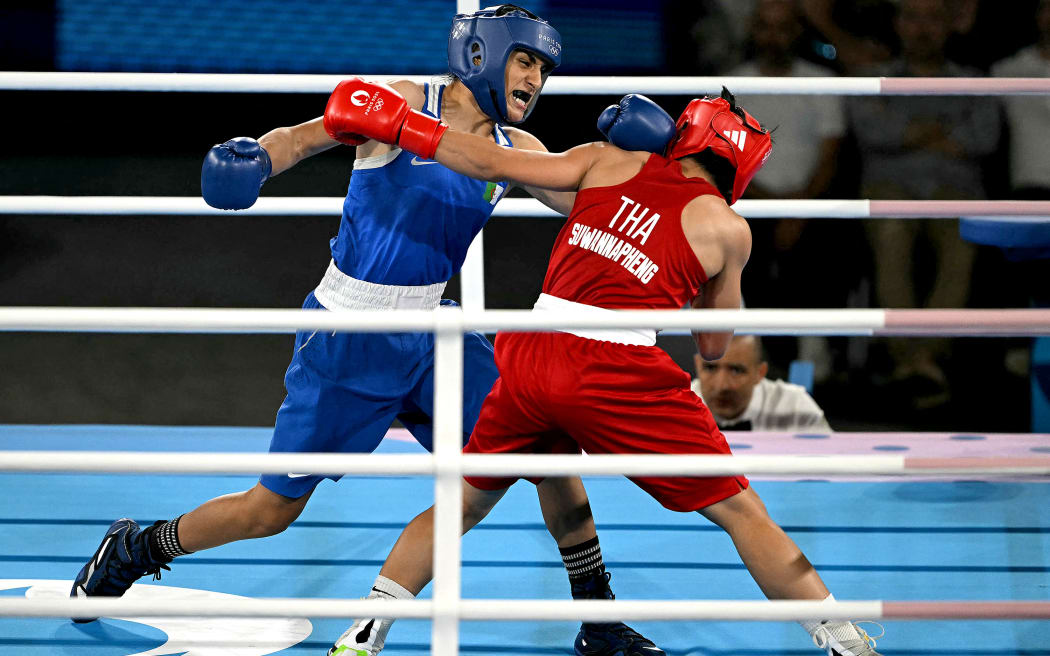 Thailand's Janjaem Suwannapheng, right,  and Algeria's Imane Khelif (Blue) compete in the women's 66kg semi-final boxing match during the Paris 2024 Olympic Games.