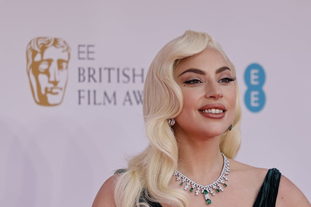 Lady Gaga poses on the red carpet at the Bafta awards in London.