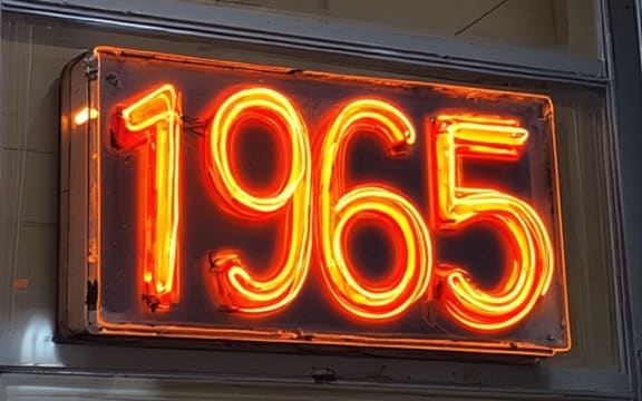 A neon sign saying "1965"