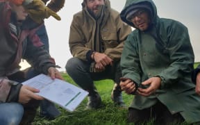 Workshop participants examine soil at the Short's farm