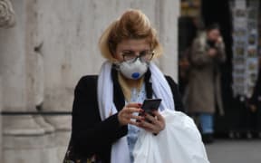 A woman wearing a face masks in Rome.
