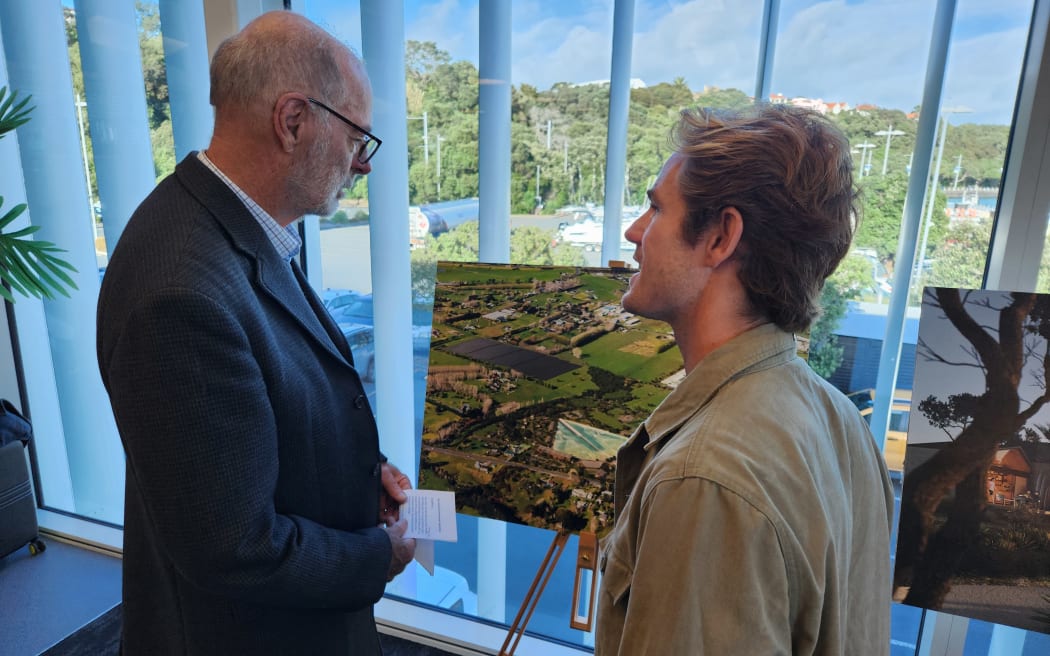 Wayne Brown and Billy Stairmand looking at a mock up of the planned surf park.