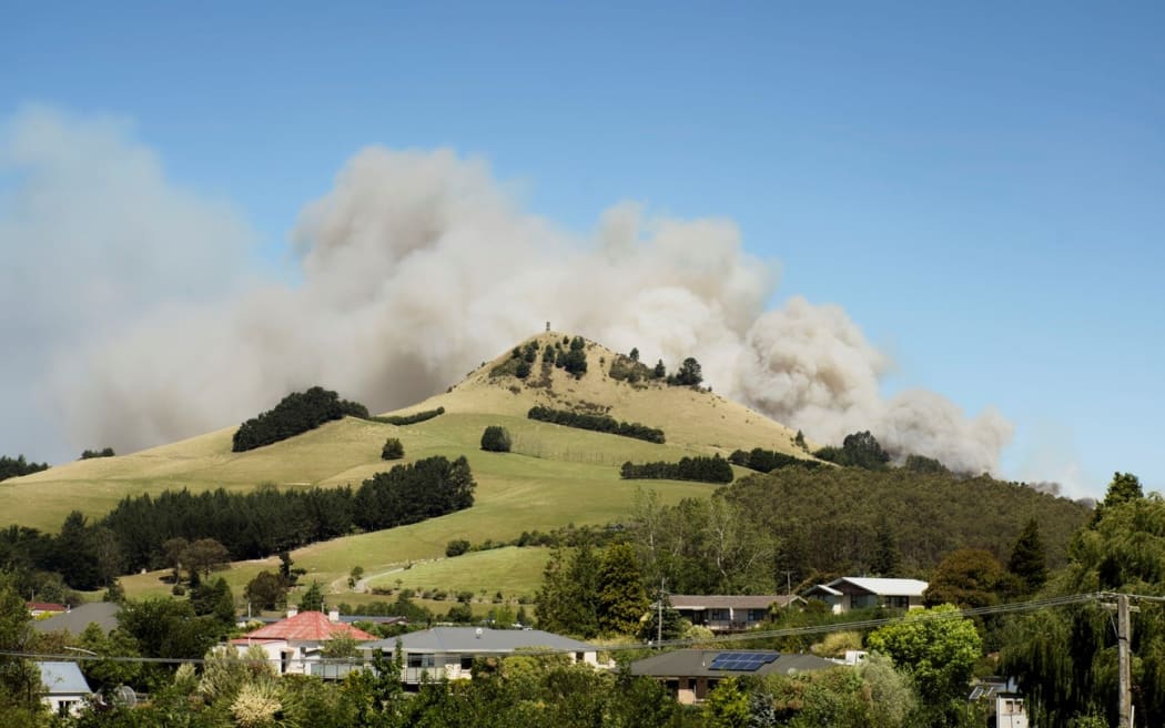 Smoke from the Goodwood fire rises above Puketapu. Photo: Dwindle River Studio