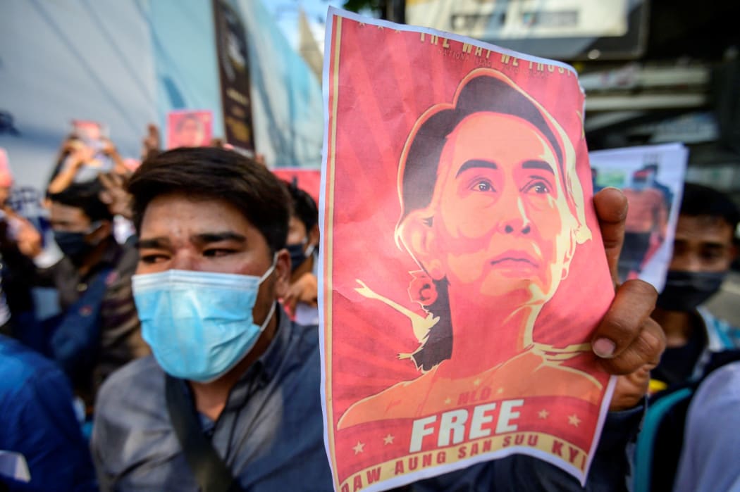 A protester holds a photo of detained Myanmar civilian leader Aung San Suu Kyi during a demonstration outside the Myanmar Embassy in Bangkok on 8 February, 2021.