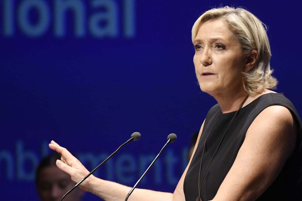 Leader of France's Rassemblement National (RN) far-right political party Marine Le Pen gestures as she delivers a speech at a meeting in Fréjus, southern France on September 16, 2018.