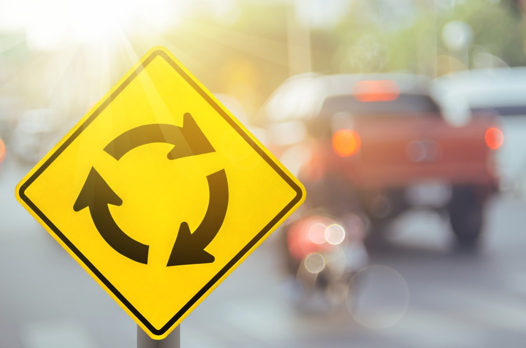 Stock photo of a roundabout sign.