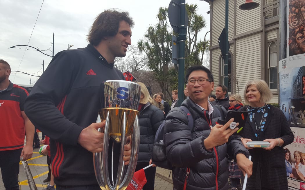 Crusaders players mingle with the public during the Super Rugby victory parade.