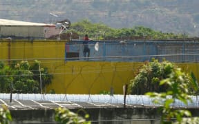 An inmate is seen at a prison in Guayaquil, Ecuador, on September 29, 2021, after a riot occurred leaving at least 100 dead.