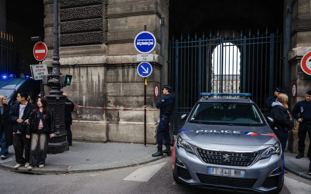 French police officers stand in front of the Louvre Museum after a robbery, in Paris on October 19, 2025. Robbers broke in to the Louvre and fled with jewellery on October 19, 2025 morning. France's Interior Minister said that jewellery stolen from the Louvre Museum was "priceless". The minister told French news outlets France Inter, France Info and Le Monde that "three or four" thieves had focused on two displays in the exhibition venue's "Gallerie d'Apollon" ("Apollo's Gallery"), completing their broad daylight robbery in just seven minutes. (Photo by Dimitar DILKOFF / AFP)