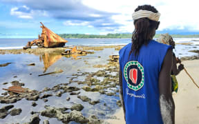 Men from Hutjena walking past the wreck of MV Solomon Queen on Buka Island, Bougainville (Supplied)