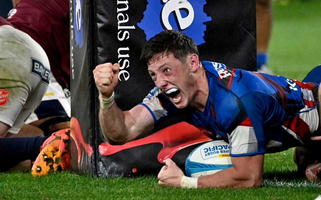 Cam Roigard of the Hurricanes celebrates a try.