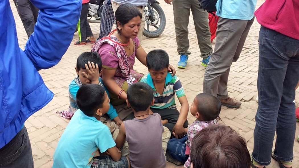 Children in Nepal are comforted following the earthquake.