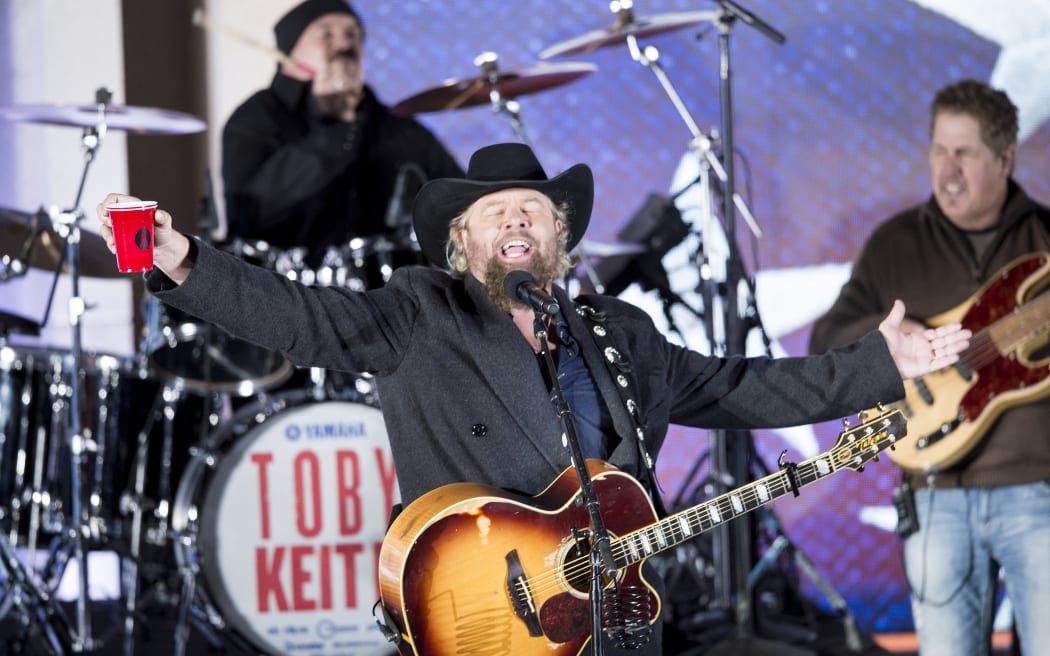 (FILES) Country singer Toby Keith performs for US President-elect Donald Trump and his family during a welcome celebration at the Lincoln Memorial in Washington, DC, on January 19, 2017. Country music star Toby Keith, celebrated in Middle America for his songs referencing communal drinking and patriotic fervour, has passed away aged 62, a statement on his social media account said on February 6, 2024. (Photo by Brendan Smialowski / AFP)