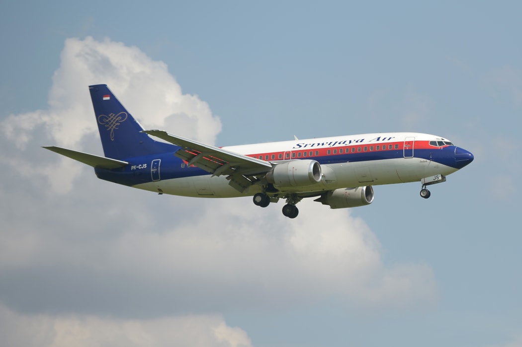 This picture taken in Tangerang on March 18, 2013 shows an Indonesian Sriwijaya air plane preparing for landing over the Sukarno-Hatta airport in Tangerang.
