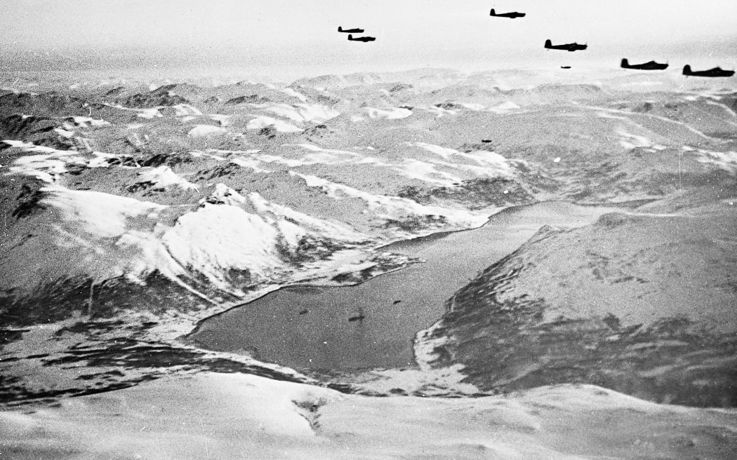 A picture taken in 1944 during WWII shows allied bombers flying above the Tirpitz, Germany's biggest battleship, sailing in a Norwegian fjord.