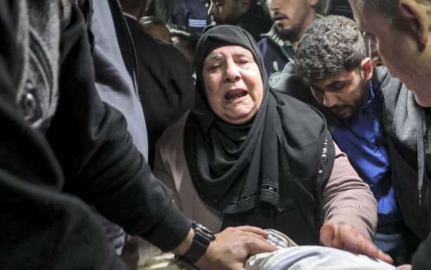 The sister of Abdel Fatah Hussein Khroushah, a 49-year-old Palestinian designated by Israeli army for being a “terrorist operative” of Hamas and accused of killing two Israeli settlers in the Palestinian town of Huwara on February 26, reacts by his body at a hospital in Nablus in the occupied West Bank.
