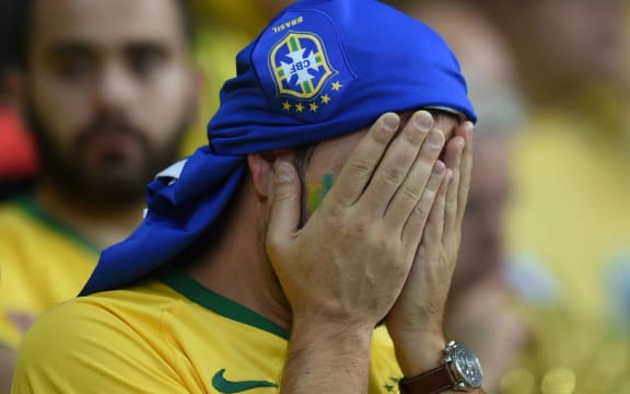 A Brazilian fan reacts to the shock loss.