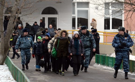 Pupils leaving school number 263, escorted by police.