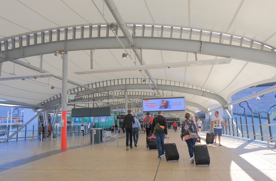 82469775 - brisbane australia - july 8, 2017: people travel at brisbane airport train station in brisbane australia.