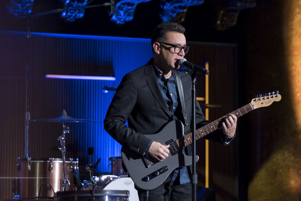 Fred Armisen playing guitar on stage during Standup For Drummers