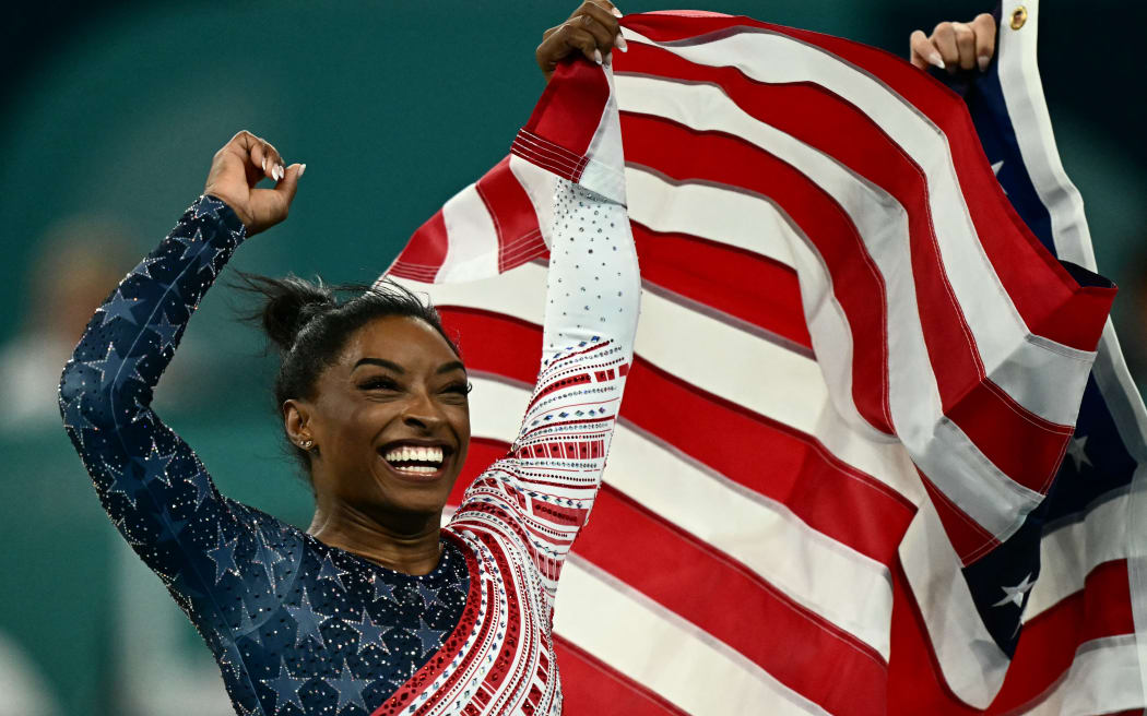 US' Simone Biles celebrates after team USA won the artistic gymnastics women's team final during the Paris 2024 Olympic Games at the Bercy Arena in Paris, on July 30, 2024.
