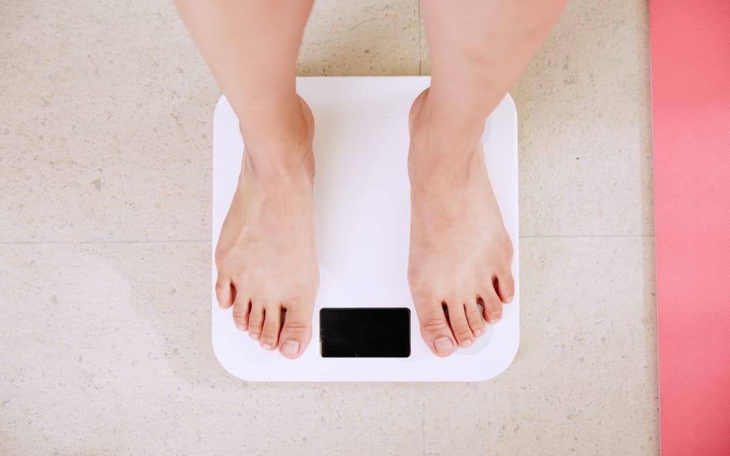 a pale-skinned pair of feet on bathroom scales