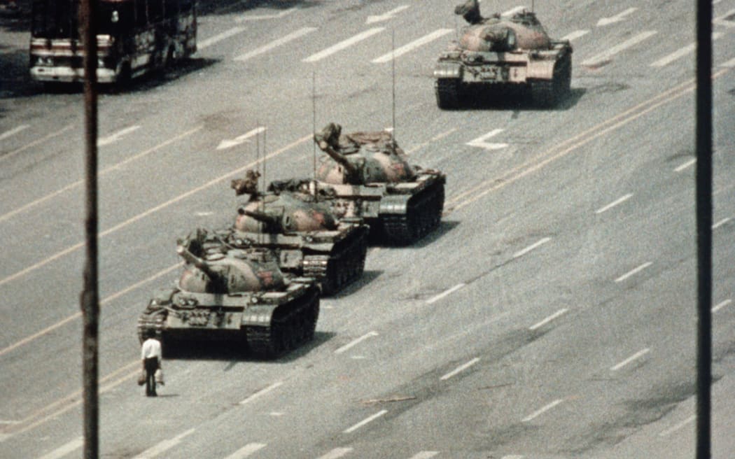A Beijing demonstrator blocks the path of a tank convoy along the Avenue of Eternal Peace near Tiananmen Square. For weeks, people have been protesting for freedom of speech and of press from the Chinese government.