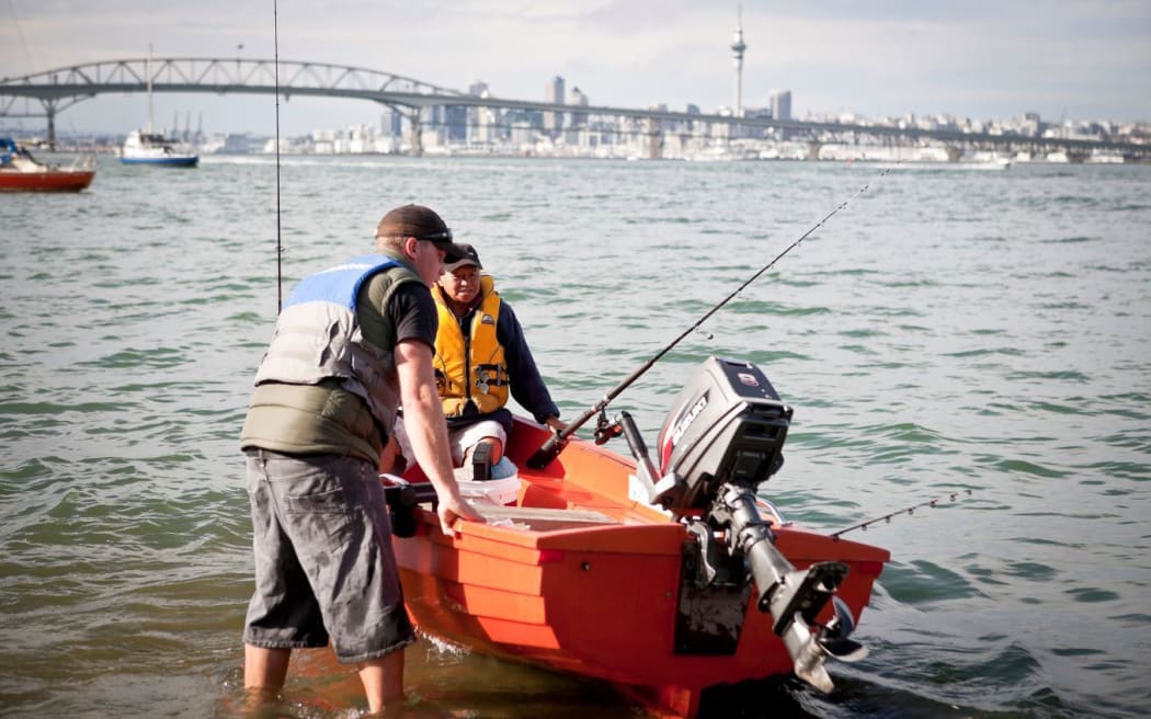 Boaties on the Waitematā Harbour wearing lifejackets, underscoring the safety message behind Auckland’s compulsory lifejacket rule that Tunumafono Fa’amoetauloa Avaula Colenso Fa’amoe MNZM helped champion.