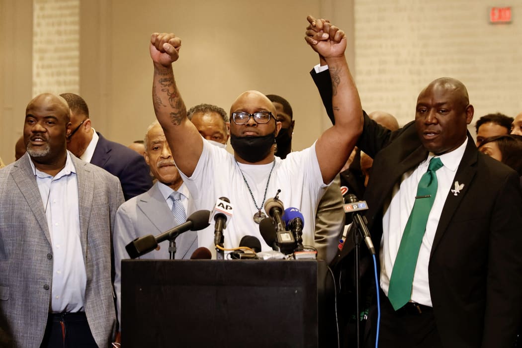 George Floyd's brother Terrence Floyd, centre, holds up his hands with family lawyer Ben Crump, right, following the verdict in the trial of former police officer Derek Chauvin in Minneapolis, Minnesota.