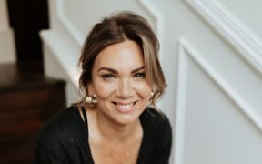 Stylist Lou Heller sits on stairs