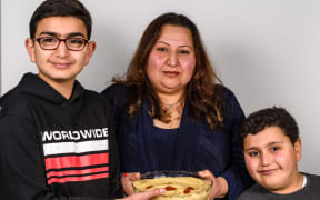 Two generations of hummus lovers with their offering
