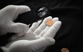 Samples of the 10 cent coin with the new 'heads' image of King Charles III are quality checked before production.