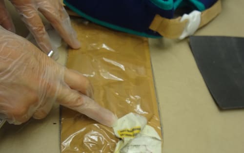 A photo released by NZ Customs shows a package containing meth found inside a baby carrier. A man from Latvia was jailed on 14 September 2016 for smuggling $1m of the drugs into New Zealand.