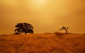 An orange sky filled with wildfire smoke hangs above hiking trails at the Limeridge Open Space in Concord, California, on 9 September, 2020.
