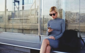 Young woman at bus stop