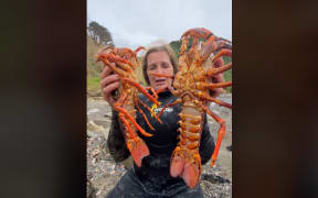 Terressa Kollat catches some crayfish on a foraging trip with a group of visitors from Australia.