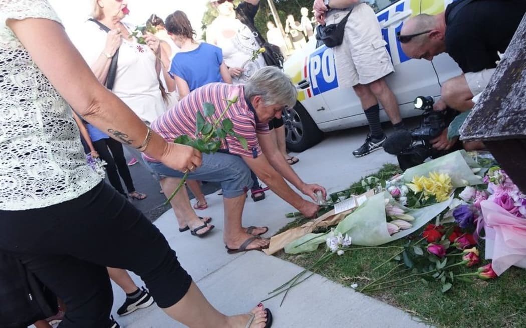 Flowers are laid at a memorial to murdered Te Atatu woman Cun Xiu Tian