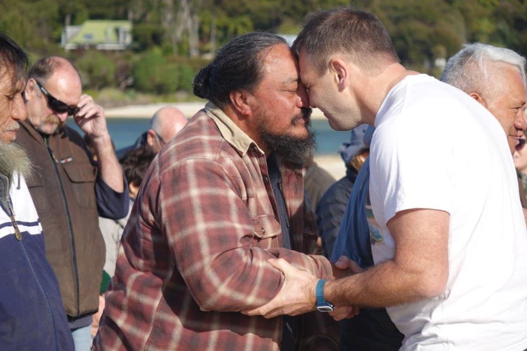 Duane Major and an iwi representive from Te Tau Ihu take part in a hongi on the beach at Awaroa.