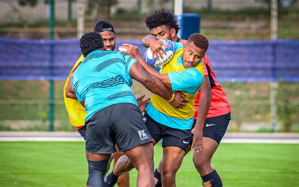 Teti Tela drives through the defence in training in Marseille.