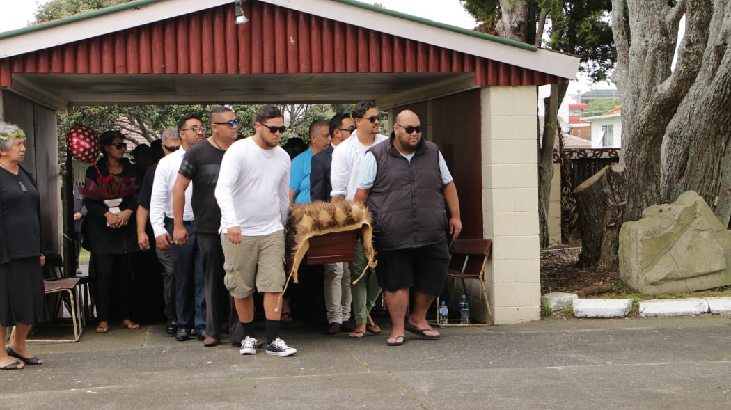 The Māori King' son, Whatumoana Paki, in white, and Tomairangi Paki's son, Turongo Paki, in black, carry her coffin into Te Puea Marae in Mangere.
