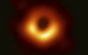 This image released Wednesday, April 10, 2019, by Event Horizon Telescope shows a black hole. Scientists revealed the first image ever made of a black hole after assembling data gathered by a network of radio telescopes around the world.