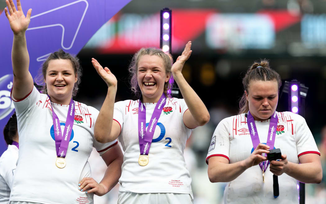 Sarah Beckett, Zoe Aldcroft, and Sarah Bern of England celebrate becoming Six Nations Champions.