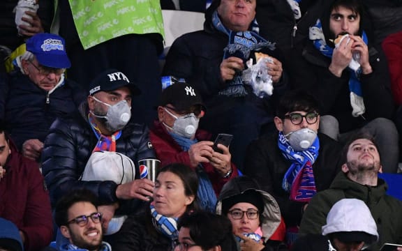 Napoli fans wearing face masks.